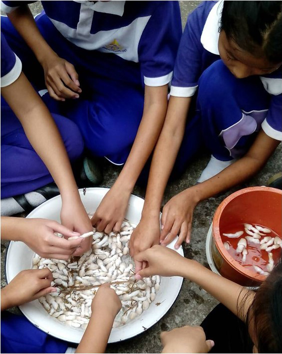 Students hand on a big bowl.